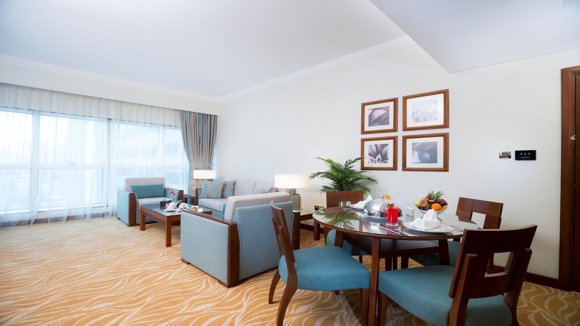 Grand Mercure Majlis Residences Αμπού Ντάμπι Εξωτερικό φωτογραφία A living room in a suite at the Jumeirah Beach Hotel